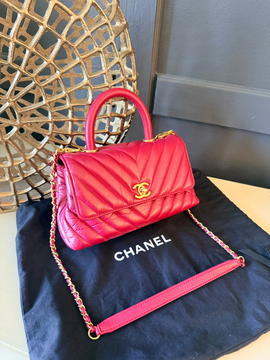 Chanel red chevron Coco Handle – Angled front view with strap
