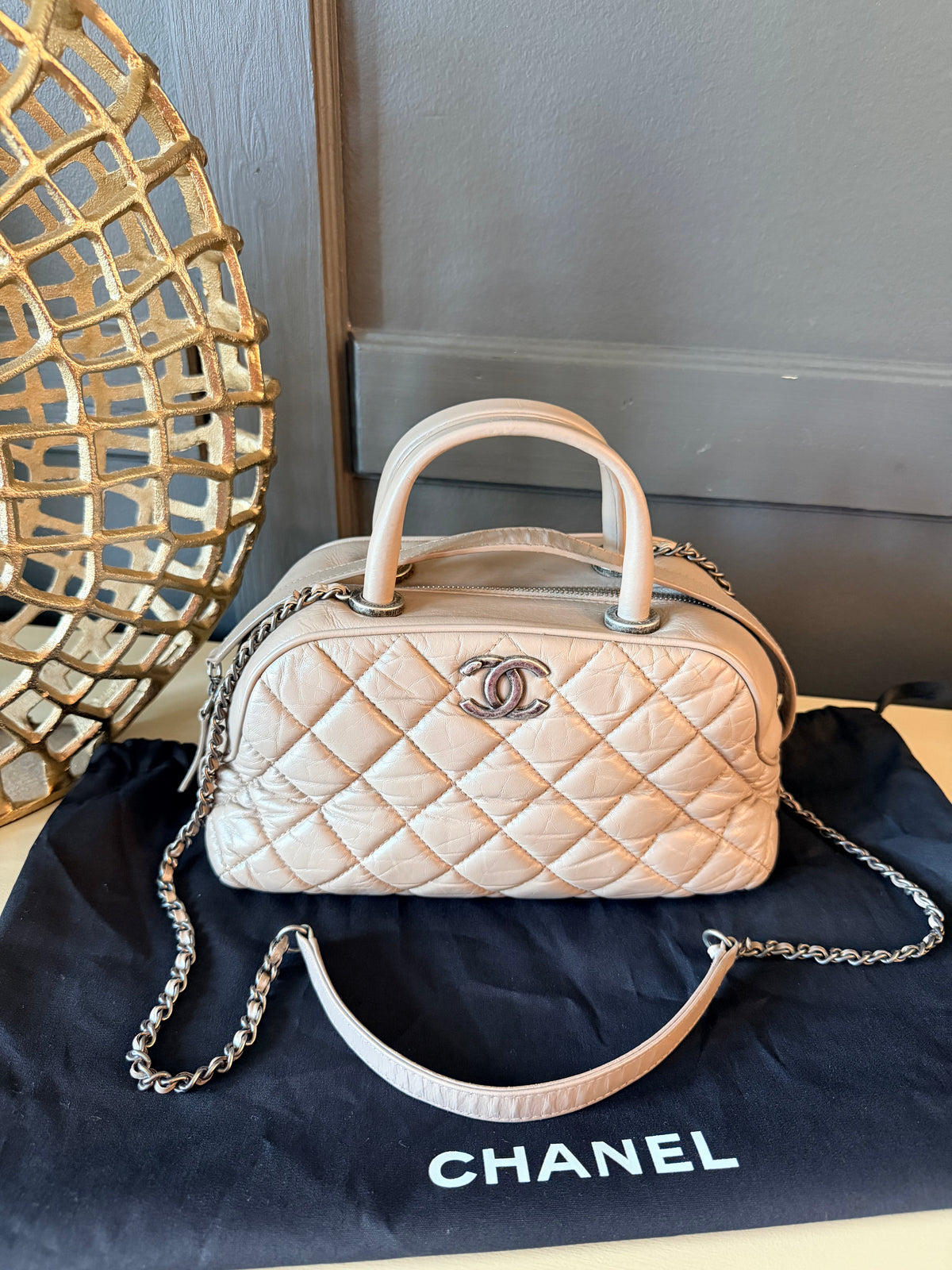 Full front view of Chanel taupe grey bowling bag with chain strap